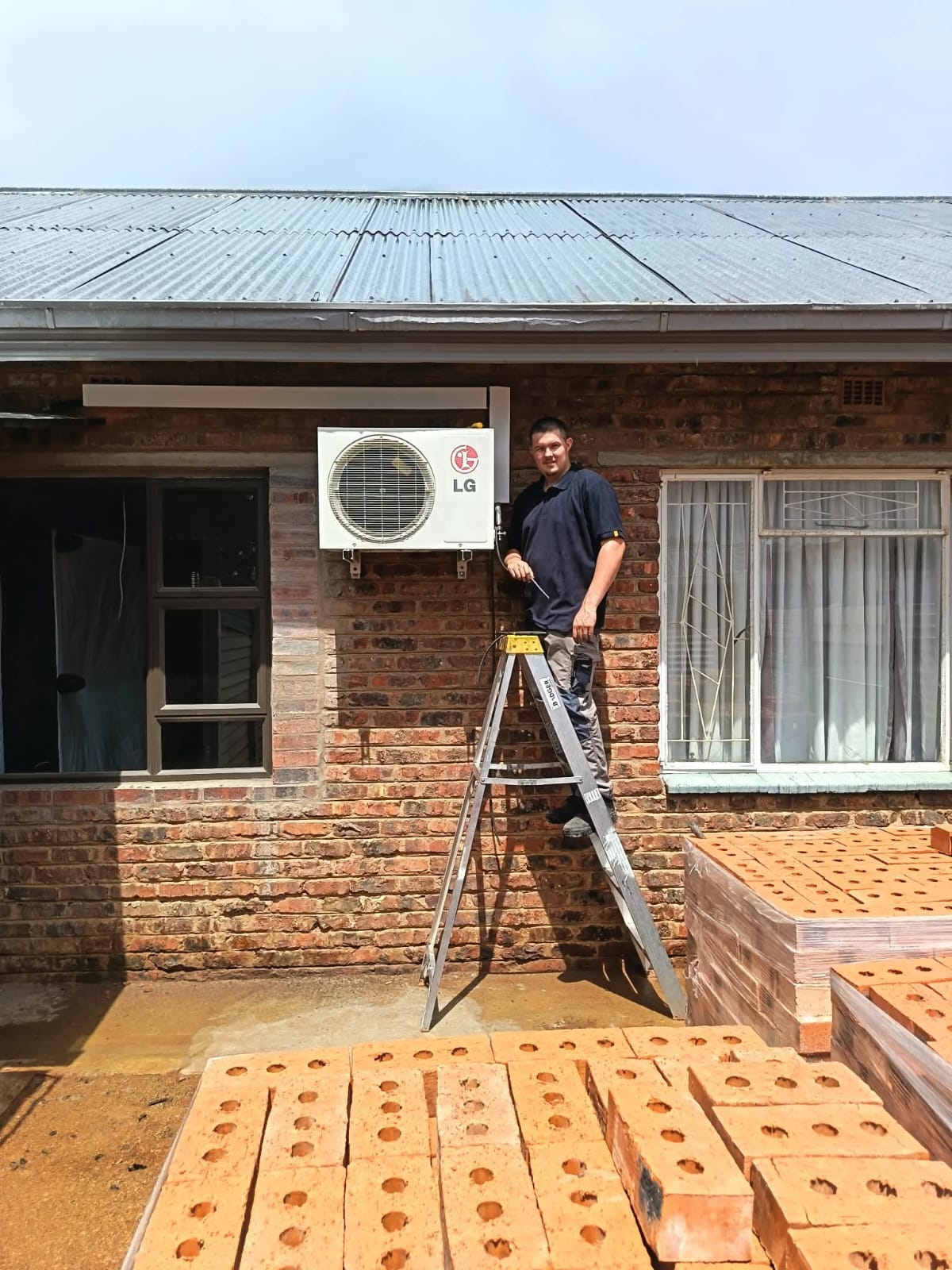 Artic Airconditioning technician installing residential air conditioning unit in Kimberley