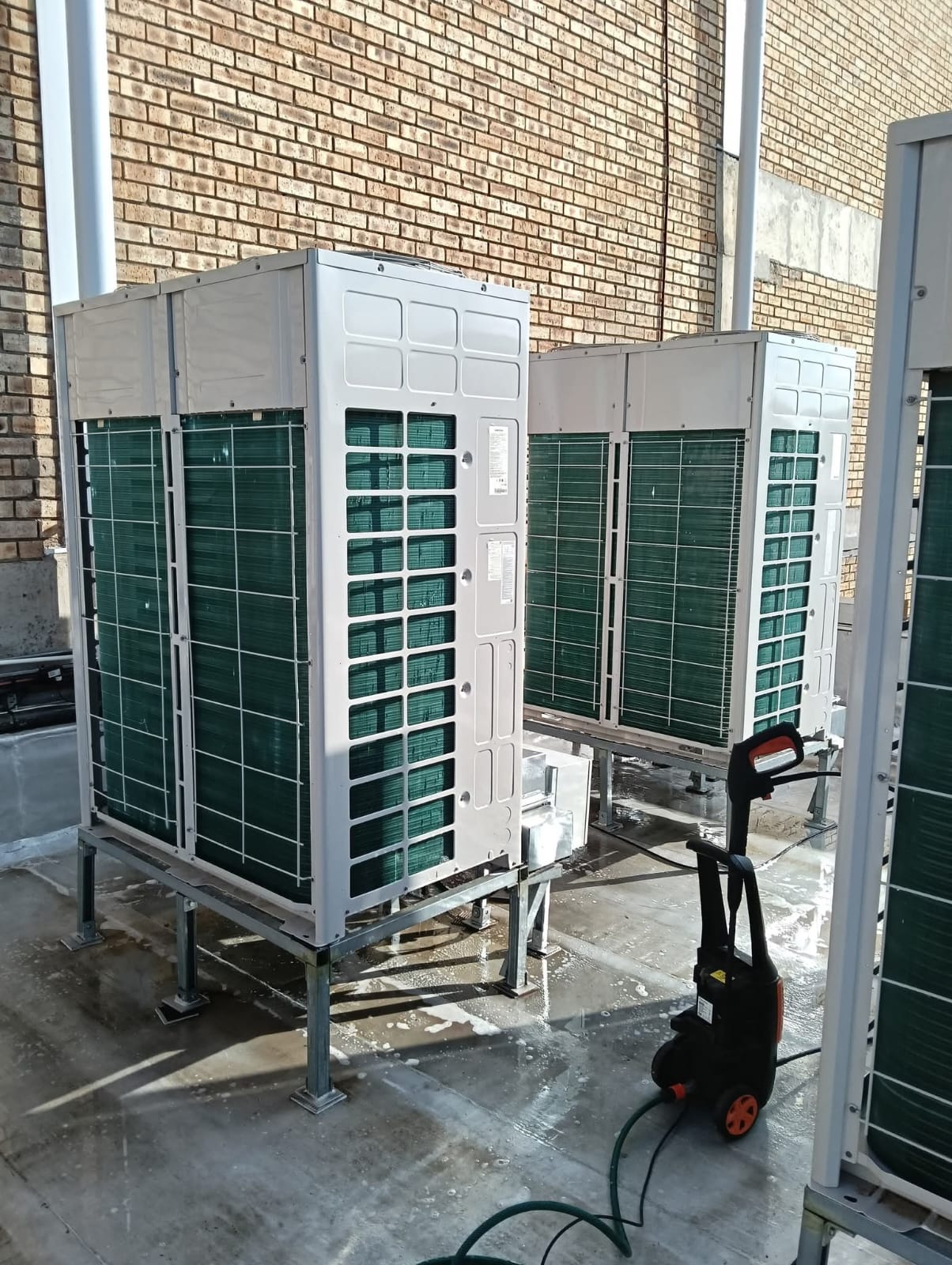 Artic Airconditioning team performing maintenance on commercial refrigeration units