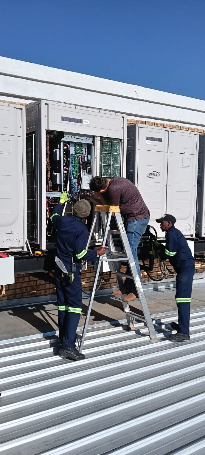 Artic Airconditioning team servicing commercial air conditioning units